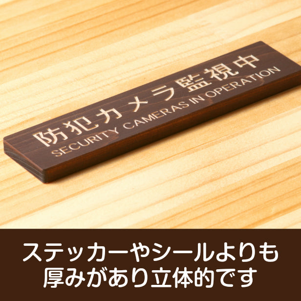 防犯カメラ監視中 英語付 木製サインプレート ダークブラウン 国産ヒノキ 防犯用プレート 監視カメラ いたずら防止 嫌がらせ対策に最適な表示サイン おしゃれ 上品 案内表示 水濡れOK 日本製 シール式 (配送2)
