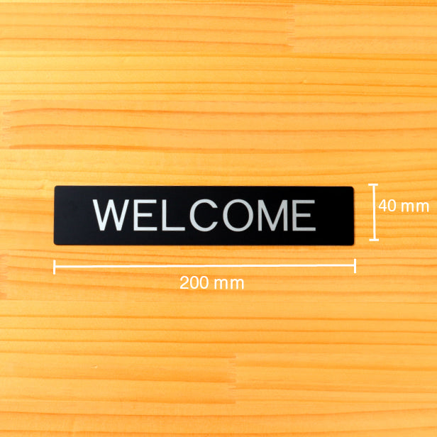 ドアプレート おしゃれなサインプレート 200×40【WELCOME】 案内標識 表示 ウェルカム オシャレ 高級感 シンプル お店 店舗 施設 会社 ホテル 病院 自宅 艶消しブラック 黒 立体印刷 高耐久 店舗やお店に最適 日本製 屋外対応 シール式 (配送2)