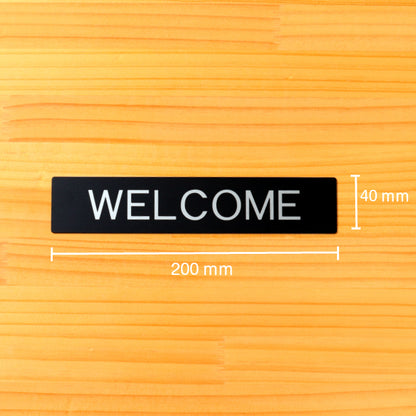 ドアプレート おしゃれなサインプレート 200×40【WELCOME】 案内標識 表示 ウェルカム オシャレ 高級感 シンプル お店 店舗 施設 会社 ホテル 病院 自宅 艶消しブラック 黒 立体印刷 高耐久 店舗やお店に最適 日本製 屋外対応 シール式 (配送2)
